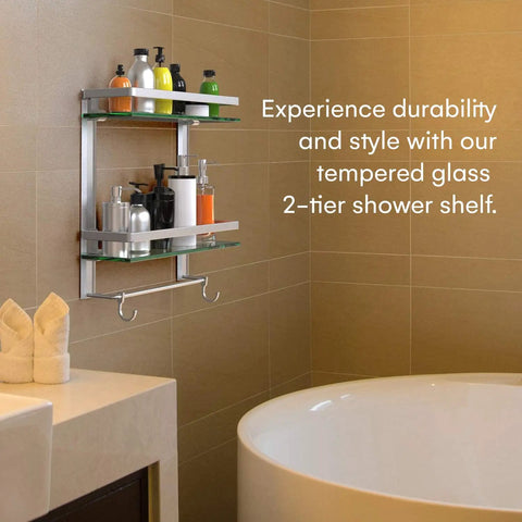 2 Tier Glass Wall Shelf With Integrated Towel Bar In Brushed Silver Finish, mounted in bathroom near bathtub holding bottles