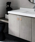 Bathroom vanity showing Four Piece Flower Shape Cabinet Knob Set In Rose Gold With Crystal Glass Pull Handles installed on cabinet doors.