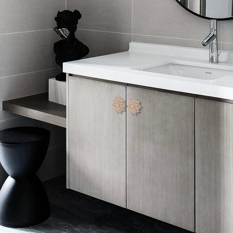 Bathroom vanity showing Four Piece Flower Shape Cabinet Knob Set In Rose Gold With Crystal Glass Pull Handles installed on cabinet doors.