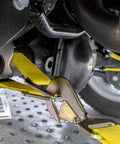 Complete Axle Strap Tie Down Kit With Snap Hook Ratchet Straps in Classic Yellow on vehicle axle for heavy-duty hauling