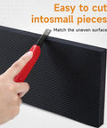 Cutting a black foam pad with a red utility knife; Garage Wall Protector For Cars And Home Heavy Duty Self Adhesive Foam Bumpers Guard Car Door Dings And Scratches 360 Degree Impact Protection Tough As Nails Tool Free Installation Durable Diamond Textured Pads