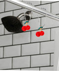 12 Pack Shower Curtain Hooks Hanging Rings for Easy Glide Curtain Rods with cherry design on shower rod.