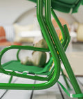 Close-up of Kids Patio Swing 2-Seater Outdoor Swing Chair With Adjustable Canopy And Safety Belt Lion Pattern, green metal frame