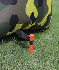 8 Pack Must Have Safety Orange Tent Stakes 8.8 Inch Plastic Anchors securing a tent in grass