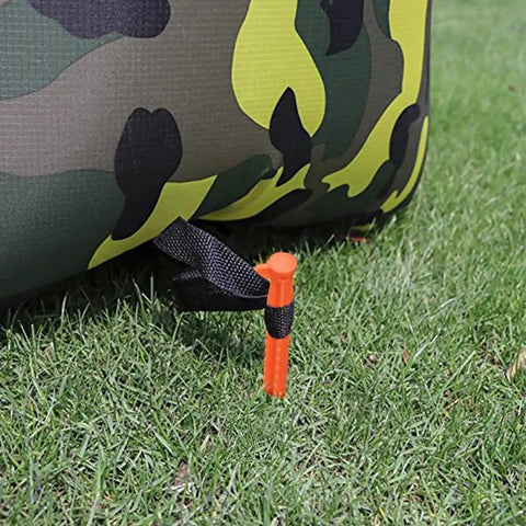 8 Pack Must Have Safety Orange Tent Stakes 8.8 Inch Plastic Anchors securing a tent in grass