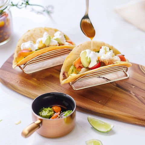4 Piece Stainless Steel Taco Holder Stand Set With V Shaped Multi Layer Taco Rack For Soft And Hard Shell Tacos on table