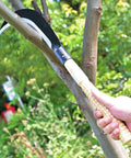 Versatile Manganese Steel Billhook Sickle Machete For Gardening And Weeding in use on tree branch outdoors