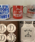 Assorted mugs and a tank top displayed with decorative coasters. Ready To Use Sublimation Transfer Sheets Set For Tumbler Tees And Mugs 14 Pieces Of 12 By 10 Inch Solid Color Insoluble Paper Pre Printed Sublimation Paper For Cricut Heat Press Mugs No Printer Needed For At Home.