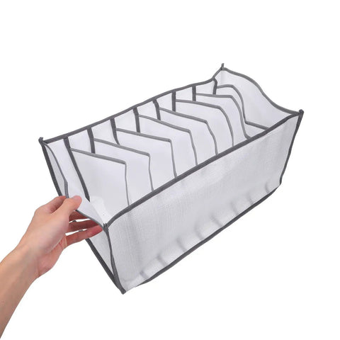 Total Closet Game Changer 3 Pack Seven Grid Foldable Bins With Grippy Handles, white fabric bin with dividers in hand.