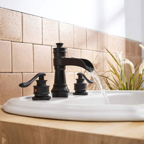 Matte Black 3 Hole Widespread Bathroom Faucet With Two Handles 8 Inch Centers Waterfall Spout Farmhouse Style Includes Pop Up Drain Assembly Supply Lines Hose Lead Free Drip Free Ceramic Cartridge Solid Brass installed on white sink in modern bathroom