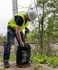 Worker using Flame-Resistant Canvas Tool Bucket, Heavy-Duty No 4 Canvas With Leather-Reinforced Handle, 100-Pound Load Rated