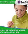 Person using Alkaline Water pH Test Strips Kit for Home Use and Liquid Testing, holding strip near liquid tester.
