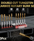 Front view of a 10-piece carbide burr set with 1/4 in shanks and gold-coated heads in a rack.