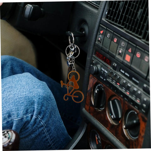 Everyday Carry Bottle Opener Keychain With Bicycle Pendant attached to car ignition, featuring compact design and durable metal.