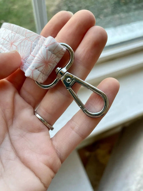 Heavy Duty Silver Swivel Lobster Clasps One Inch Metal Snap Hooks Built Boss Tough For Purses Bags And Secure Key Chains close-up view in hand.