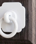 Four Pack Satin White Cabinet And Bifold Ring Pull Handles With One And Three Fifths Inch Backplate installed on wood cabinet door