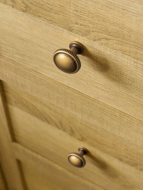 Top Shelf Antique Brass Cabinet Knobs Six Pack Round Single Hole Kitchen Furniture Hardware Easy DIY Install Vintage Inspired Close-up on drawer.