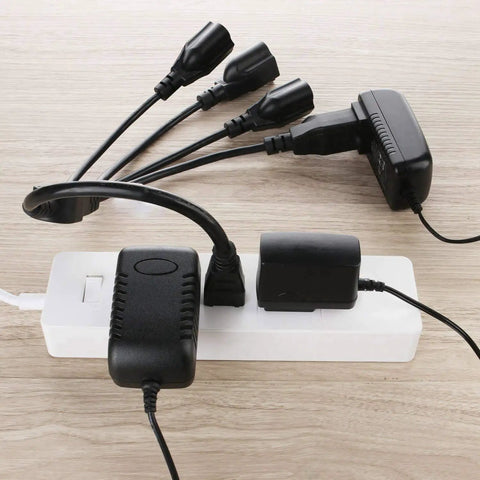 Three Prong To Four Way Power Cord Splitter 20 Inch Heavy Duty Extension Cord in use, connected to multiple devices on a power strip.