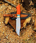 Dope Copper Damascus Fixed Blade Knife With Resin Handle resting on premium leather sheath for bushcraft camping outdoor hunting