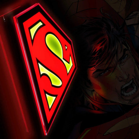 Superman Table Lamp And Night Light With Luminescent Halo, 3D S Shield Crest Wall Light Mountable, glowing in dim room.