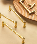 Gold Brass Bamboo Shape Cabinet Handles Set with Antique Brushed Copper Finish shown on a wooden tray, includes screws.