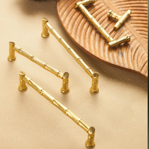 Gold Brass Bamboo Shape Cabinet Handles Set with Antique Brushed Copper Finish shown on a wooden tray, includes screws.