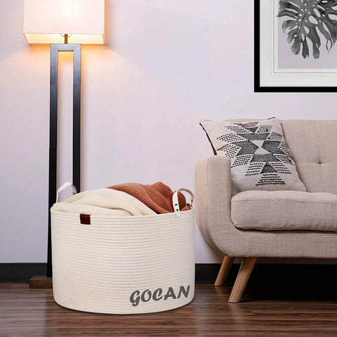 XXXL Cotton Rope Storage Basket With Handles Extra Large 22x22x14 Inches in cream beside couch with blankets.