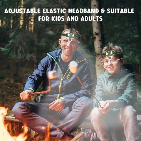 Kid Friendly LED Headlamp For Outdoor Adventures With Roar And Silent Modes in use during camping by campfire with dad and son