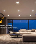 Living room illuminated by 12 Pack 4 Inch Retrofit LED Recessed Lighting with E26 Adaptor, stylish modern decor, evening ambiance.