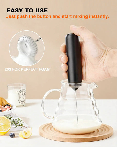 Rechargeable Milk Frother Wand With Cover Electric Drink Mixer With Stainless Steel Whisk in use over a glass jug of milk
