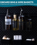 All In One Pegboard Organizer Kit With 246 Pieces Hooks Bins Baskets Paper Towel Holder For One Eighth And One Quarter Pegboard Garage Tool Storage And Hanging Solutions to keep your shop on point, showing wire baskets holding bottles.