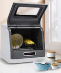 Premium Portable Countertop Dishwasher Built From Heavy Duty Stainless Steel with plates inside, perfect for small kitchens.