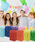 Children at a party with 4 Pack Gift Bags With Handles 8 X 5 X 10 Inch Includes 8 Tissue Paper Color Combo Pink Purple Deep Blue Sky Blue