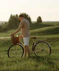 Man with bicycle in field, suitable for All Purpose 700X35C To 43C Bike Inner Tube With Schrader Valve Reliable Replacement For City Road Gravel Bikes