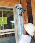 Worker using XGC01Z Cordless 18V Caulk And Adhesive Gun With Beefy 1100 Lbs Dispensing Power for window sealing on construction site.