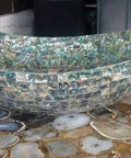 Top Shelf Oval Marble Vessel Sink With Real Abalone Shell Detailing And 24 By 19 Inch Bathroom Basin on a textured counter.