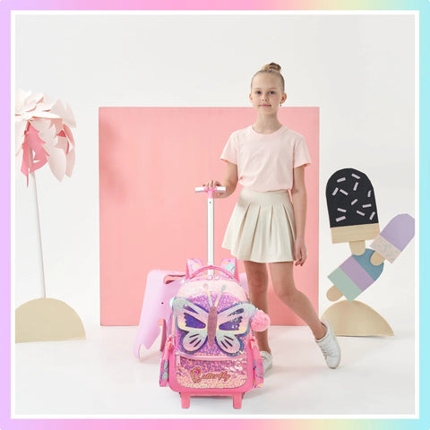 Pink rolling backpack with glitter butterfly wings; front view shows pink wheeled luggage beside girl.