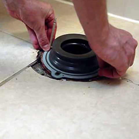 Hands placing Perfect Seal Toilet Wax Ring With Bolts No Mess Installation Repositionable Toilet Seal on bathroom floor flange.