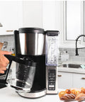 Person holding Replacement Glass Carafe For Ninja Coffee Maker 12 Cup Fits CE251 CE201 CE201C CE200 CE200C Model XGLSLID200