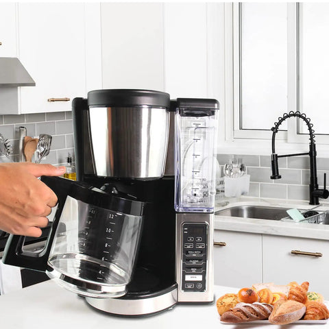 Person holding Replacement Glass Carafe For Ninja Coffee Maker 12 Cup Fits CE251 CE201 CE201C CE200 CE200C Model XGLSLID200