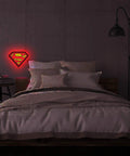 Superman Table Lamp And Night Light With Luminescent Halo on wall above bed, Justice League Inspired Hero Lighting.