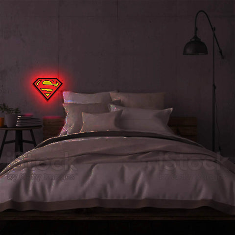 Superman Table Lamp And Night Light With Luminescent Halo on wall above bed, Justice League Inspired Hero Lighting.