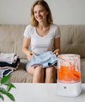 Woman using Grab And Go Portable Mini Washing Machine Usb Rechargeable Compact Drum with laundry, suitable for underwear and socks.
