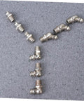 Assorted zerk fittings from the 45 Piece Grease Fitting Assortment Kit with straight bend and elbow styles on display.