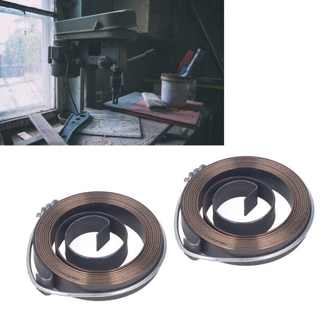 Two Piece Drill Press Quill Spring Set in spring steel with blackening finish, shown alongside a bench drill in a workshop setting.