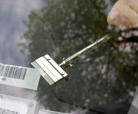 Long Handle Adhesive And Vinyl Decal Remover With Razor Blade Scraper peeling off decal from car window