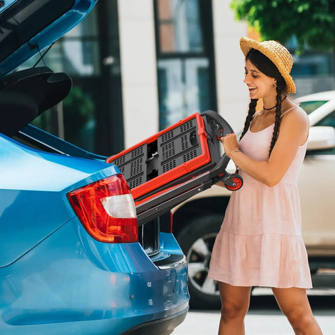 Woman lifting collapsible shopping cart with wheels 200 lb capacity grocery cart on wheels with storage crate into car trunk