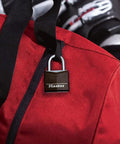 1-3/16 Inch Wide Covered Aluminum Keyed Padlock in black on red locker bag; tough as nails steel shackle, four pin cylinder