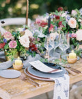 Elegant table setting with floral arrangements and Eight-Hour Smokeless Dripless Ivory Votive Candles Bulk Pack Of 72 Sticks