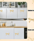 Bow Shape Cabinet Knobs Set Of 6 Brass Vintage Gold Finish Drawer Pulls installed on white kitchen cabinets